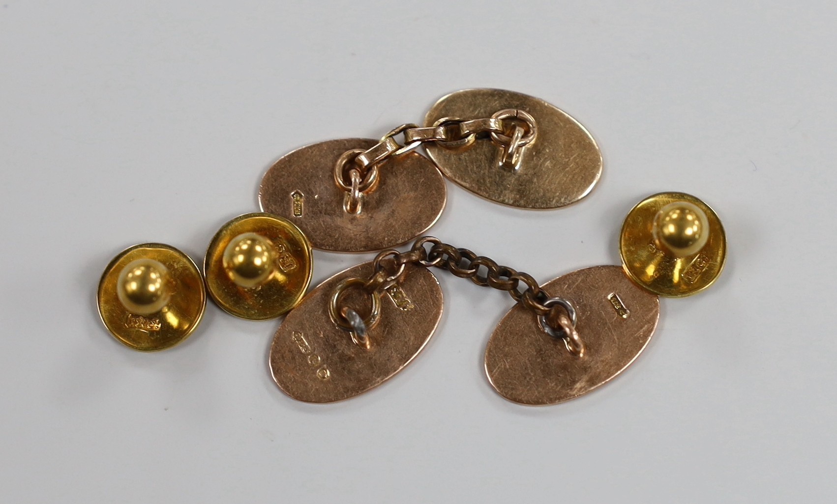 A pair of 9ct. gold oval cufflinks, 7.9 grams and three 18ct dress studs, 4.1 grams.
